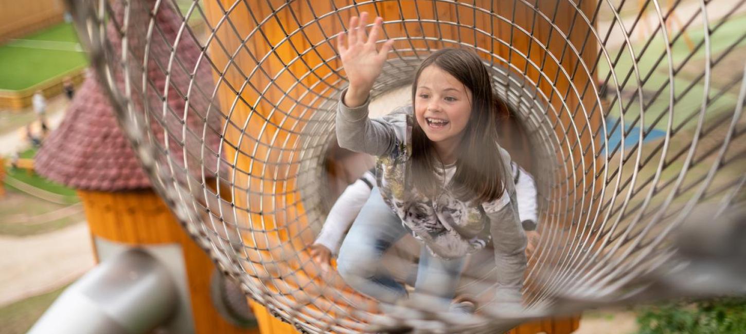 Ein Mädchen im Turm des Naturspielplatzes in Juelsminde